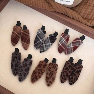 12-piece set of plush autumn hair clips with plaid and leopard prints in a tray