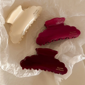 Three acetate hair claws in cream, pink, and dark red with Barrette La France text