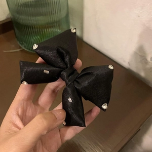 Handheld black satin bow hair tie with sparkling rhinestones for elegant styling