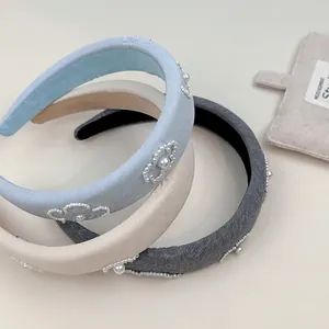 Three Korean style thick sponge headbands in blue, beige, and grey with pearl heart motifs