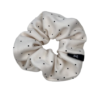 Minimalist cream white polka dot headband with black logo tag and bow pattern