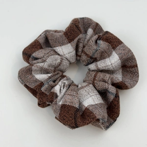 Macro detail of large checkered scrunchie showing premium woven fabric texture
