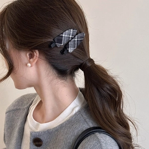 Elegant black and white plaid plush hair clips for women on dark brown ponytail