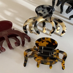 French vintage pumpkin-shaped acetate hair claw clips in various tortoiseshell patterns