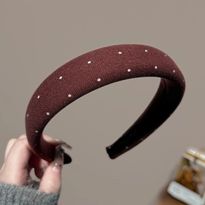 Detail of burgundy sponge headband with silver polka dots and soft velvet texture