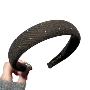 Elegant black padded polka dot sponge headband with silver rhinestones on white background