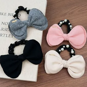 Lot de quatre chouchous en laine avec nœuds, perles blanches et petits bijoux dorés