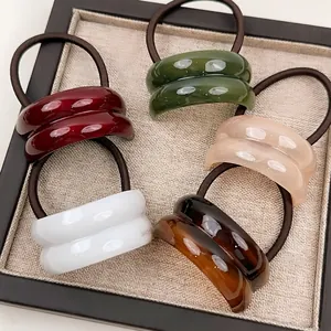 Minimalist geometric resin hair ties in five colors with high-gloss finish and elastic cords