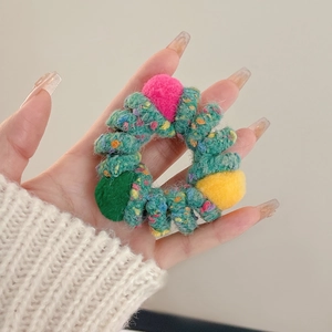 Colorful plush knit scrunchie with colorful pom-poms for durable elastic hair styling