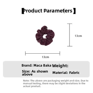 Detail view of deep purple plush hair scrunchie showing the 13cm outer diameter size