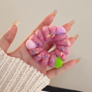 Pink wool spiral telephone cord hair tie with colorful plush bean pom poms