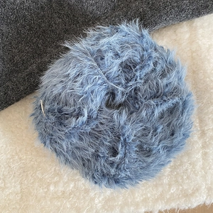 Close-up of a blue faux fur plush scrunchie showing detailed long fiber hair texture