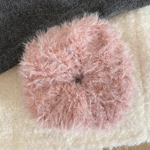 Close-up of pink faux fur scrunchie showing soft long fibers and plush texture