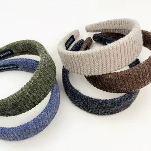 Detailed view of handmade knitted headbands in assorted colors with textured yarn fabric