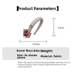 Detail view of beige fabric headband with metal bow logo and 13.5cm diameter size specs