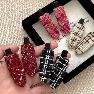 Set of four tweed water-drop hair clips in assorted plaid patterns on metal base