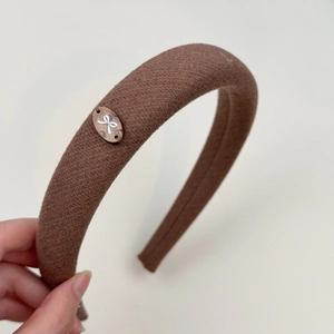 Retro brown padded sponge headband with twill fabric and vintage metal bow charm detail