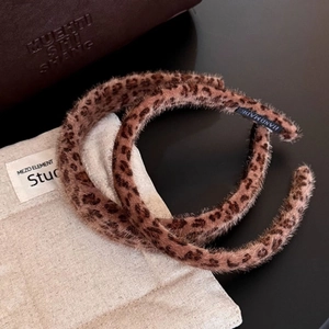 Handmade leopard print plush headband featuring soft faux fur texture for women