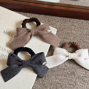 Chic knitted bow hair ties with metal charms in autumn brown, grey, and cream colors