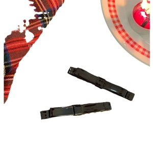 Set of two black patent leather bow hair clips with elegant minimalist design