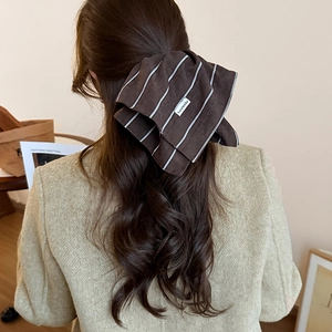 Brown striped bow hair scrunchie with handmade label for elegant autumn hair styling