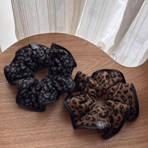 Large leopard print scrunchies in brown and grey knit fabric for elegant ponytails