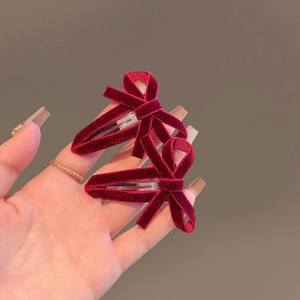 Close-up of velvet red bow hair clips showing premium fabric texture and craftsmanship