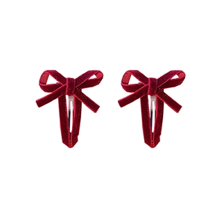 Pair of elegant red velvet hollow bow hair clips with metal duckbill base for women