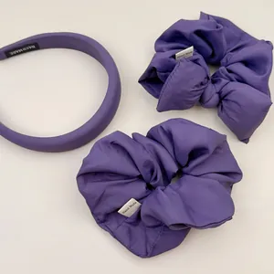 Detail of purple padded headband and scrunchies set in premium matte satin fabric