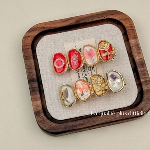 Retro red flower barrette clips with dried flowers and pearls on a wooden tray