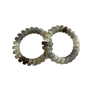 Set of spiral telephone cord hair ties in translucent smoky grey and olive green resin