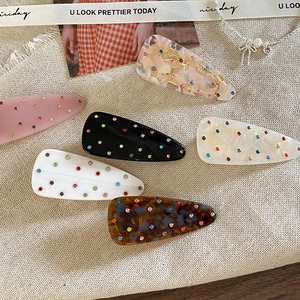 Set of 6 sweet teardrop hair clips with colorful rhinestones on soft fabric background