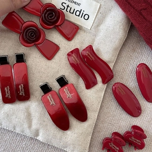 Vintage red acetate hair clip set with camellia floral accents for elegant hair styling