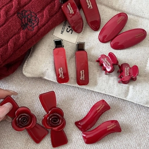 Vintage burgundy acetate hair clip set including floral bow and geometric duckbill clips