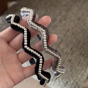 Elegant wave-shaped velvet headbands with pearl accents in black and grey for women