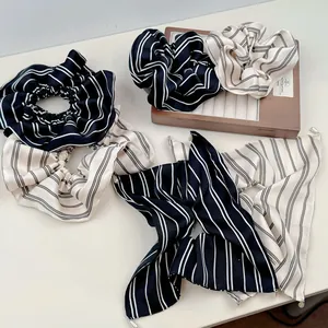 Detail view of French vintage striped scrunchie with long ribbons and pearl pendant charm