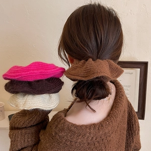 Plush knitted oversized scrunchies in various colors for an elegant ponytail look