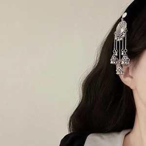 Ethnic vintage silver tassel earrings with delicate hollow bell pendants on model