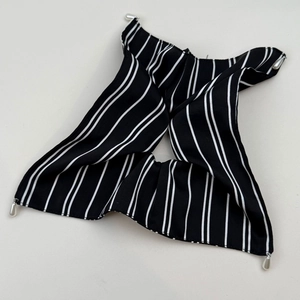 Detail of French retro black and white striped hair tie with elegant pearl charms