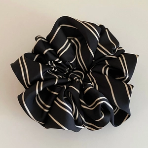 Elegant black and white striped satin scrunchie with large pleated floral structure