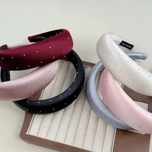 Padded satin headbands with silver rhinestones in burgundy, black, and pastel colors