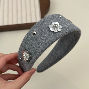 Detail view of grey wool headband with silver flower petals and sparkling rhinestones
