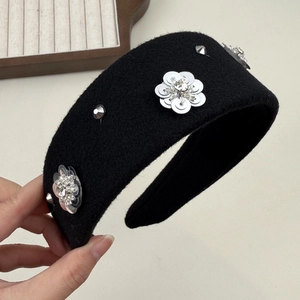 Detail of black wool wide headband with silver sequins and metallic floral accents