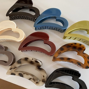 Minimalist heart-shaped hair claw clips in diverse colors and patterns for women