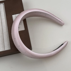 Detailed view of pink satin sponge headband with silver beads and black anti-slip lining