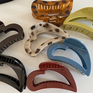 Retro hollow heart hair claws in various colors like tortoiseshell and solid matte resin