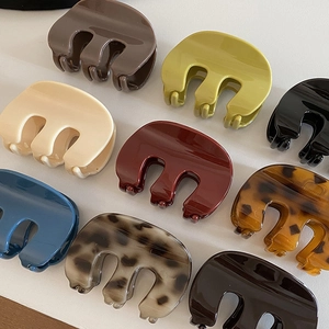 Vintage M-shaped hair claw clips in various glossy colors and patterns for women's updos