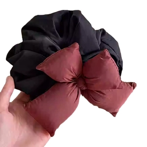 Elegant oversized dark red bow scrunchie made of pleated black elastic fabric for hair