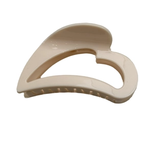 Minimalist beige heart-shaped hair claw clip with a glossy finish for elegant styling