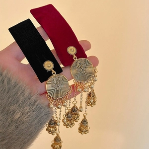 Ethnic gold tassel earrings with hollow bells and round filigree on velvet cards